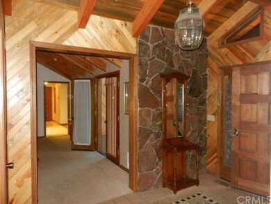 Welcoming formal entry with tile, rock & woodwork