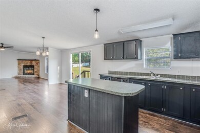 Kitchen Area w Sink Overlooking Backyard