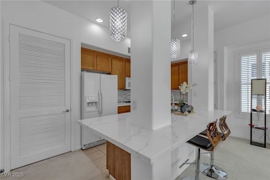 Kitchen with tasteful backsplash, white fridge wit