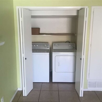 Closet with full sized washer and dryer