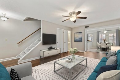 Living room with dark wood-type flooring and ceili