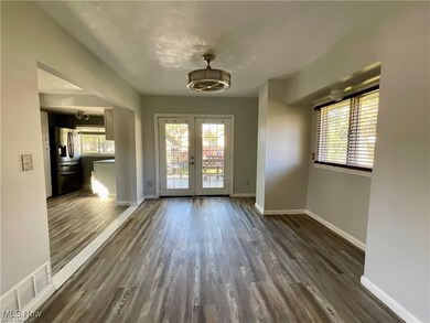 Entrance foyer featuring french doors, dark wood-style flooring, and plenty of natural light