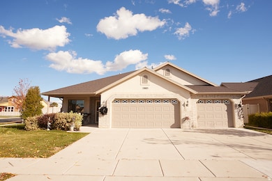 Ranch-style house featuring concrete driveway, a garage, and a front lawn