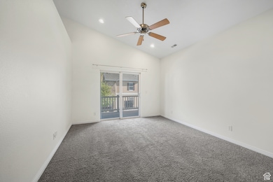 Empty room with high vaulted ceiling, carpet, a ceiling fan, and recessed lighting