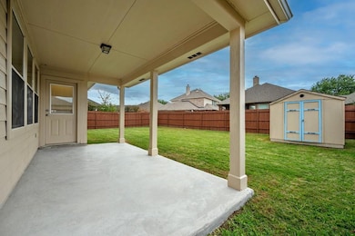 View of patio / terrace featuring a storage shed
