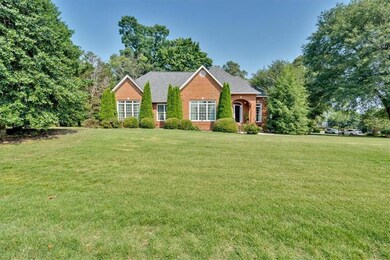 View of front of house featuring a front yard and brick siding