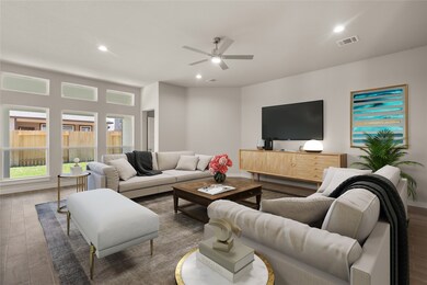 Gather the family and guests together in your lovely living room! Featuring high ceilings, recessed lighting, dark stained ceiling fan, custom paint, gorgeous floors, and large windows that provide plenty of natural lighting throughout the day.
