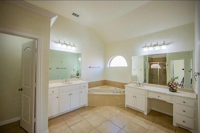 Bathroom with lofted ceiling, plus walk in shower, tile patterned flooring, and vanity