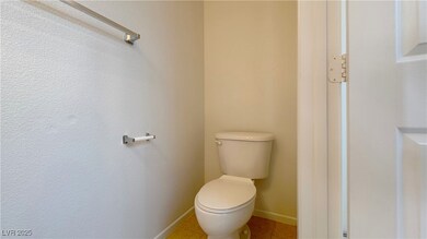 Bathroom with toilet and tile patterned flooring