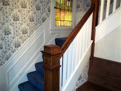 Gracious entry hall with stained glass window.