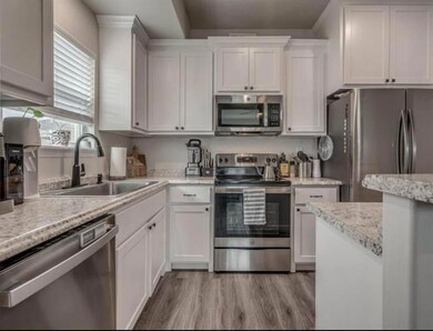 Kitchen with appliances with stainless steel finis