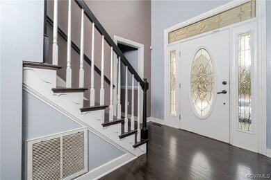 Foyer with dark wood-type flooring