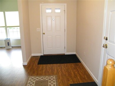 Front door into the foyer with the garage door on 