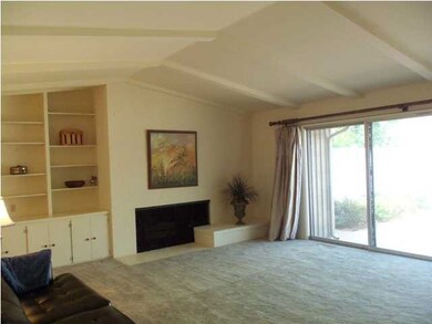 Large windows in living room overlook front patio