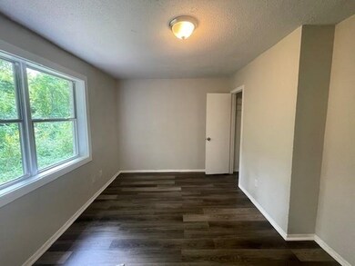 Unfurnished room featuring dark hardwood / wood-st