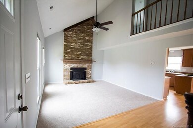 Vaulted living room with cozy wood-burning firepla