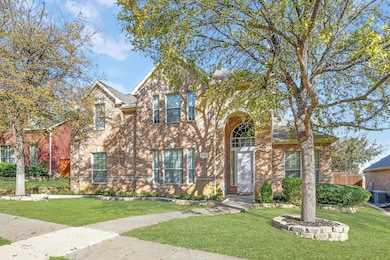 Traditional-style home featuring brick siding
