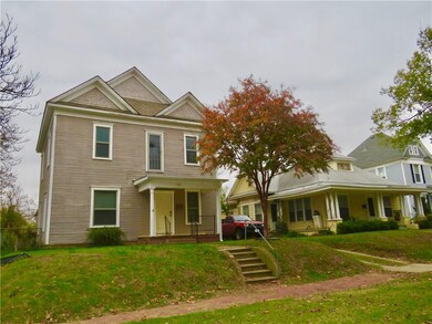 Street view of property. Sidewalk and stairs in front.