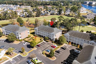 Drone / aerial view of a large body of water and a local golf course