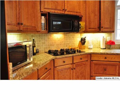 Granite counters and tile back splash enhanced wit