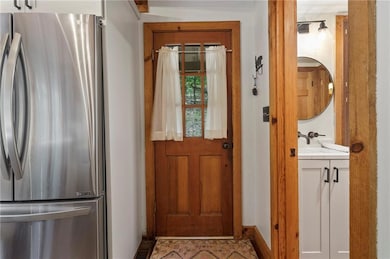 Doorway to outside featuring sink