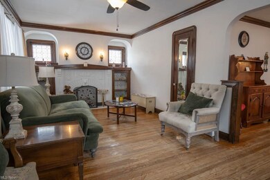 The living room features hardwood floors and origi
