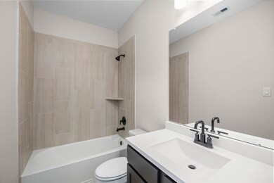 This secondary bathroom has a stylish vanity with