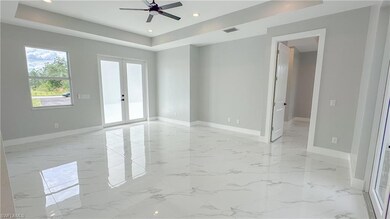 Empty room with french doors, ceiling fan, and a r