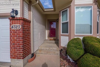 Doorway to property featuring a garage and brick siding