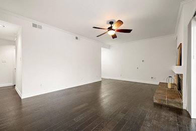 Unfurnished living room featuring dark wood-type 