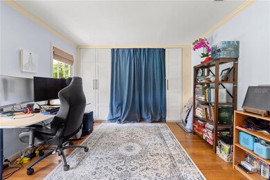 Office featuring wood finished floors and ornamental molding