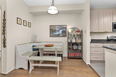 The cozy dining area features a charming chandelie