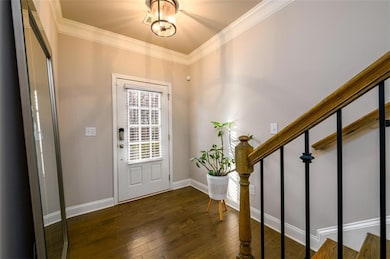 Foyer entrance with baseboards, stairs, ornamental