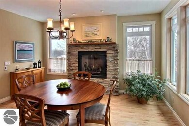 with fireplace and large windows overlooking woode