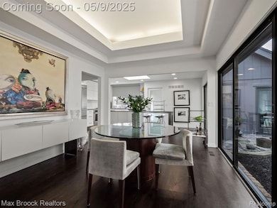 Dining room with accent lighting and tray ceilings