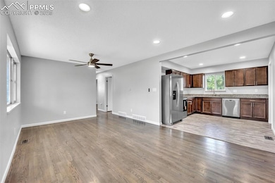 Unfurnished living room featuring ceiling fan, wood finished floors, recessed lighting, and a textured ceiling
