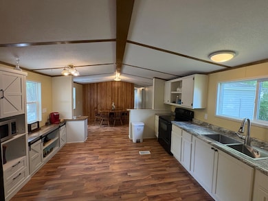 A Kitchen with tons of space, new countertops, and room for an island if one wanted.