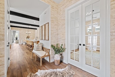Upon entering you're greeted with a stone entryway immediately setting the tone for this property. French doors open to the office or second living space.
