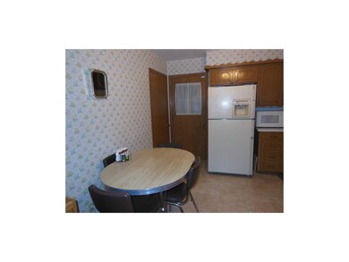 Kitchen has entrance to basement and garage.