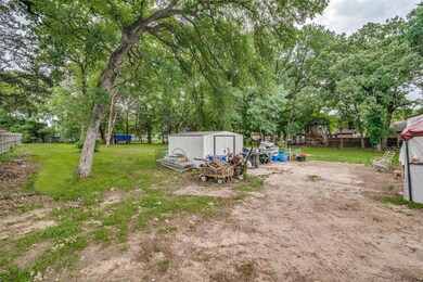 View of yard with an outdoor structure, fence, and