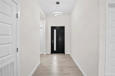 Foyer featuring light hardwood / wood-style flooring and a notable chandelier