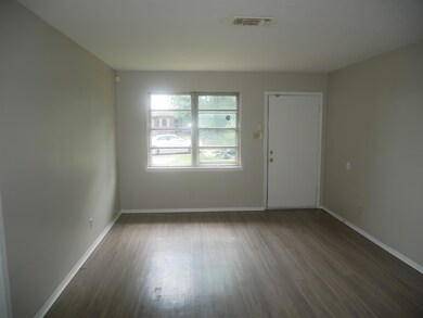 Empty room with wood finished floors and baseboards