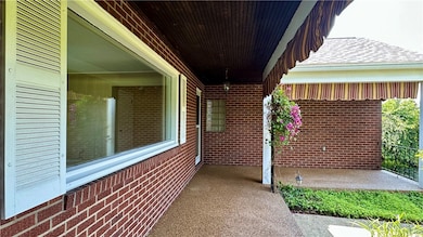 ALTERNATE VIEW OF COVERED FRONT PORCH WITH BEAUTIF