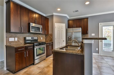 Kitchen featuring appliances with stainless steel