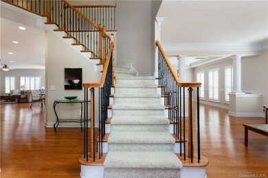 Grand foyer with striking stairway.  Hardwood floo