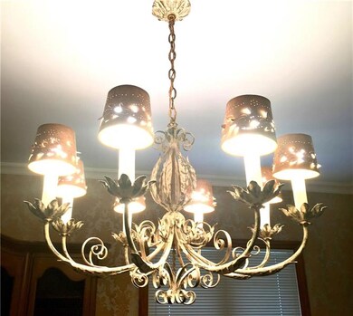 A gorgeous chandelier and large windows make this 
