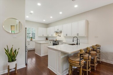The modern kitchen is open to the living and break