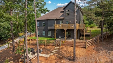 Back of property with a deck, stairs, a shingled roof, and a fenced backyard