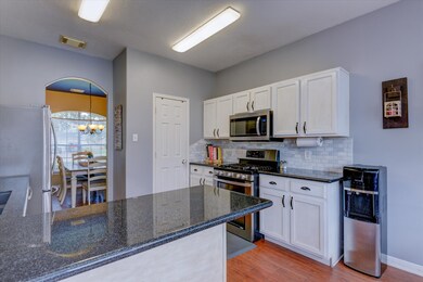 The kitchen features granite countertops, stainles