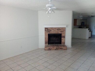 Unfurnished living room featuring a brick fireplac